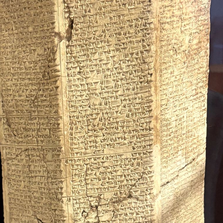 Close view of cuneiform writing pressed in ruled columns into clay